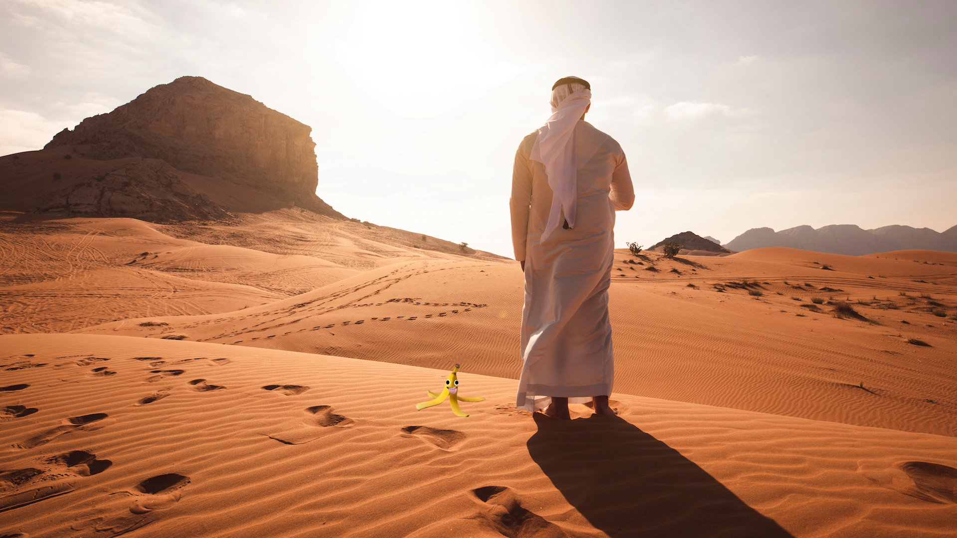 A man standing on a sand dune