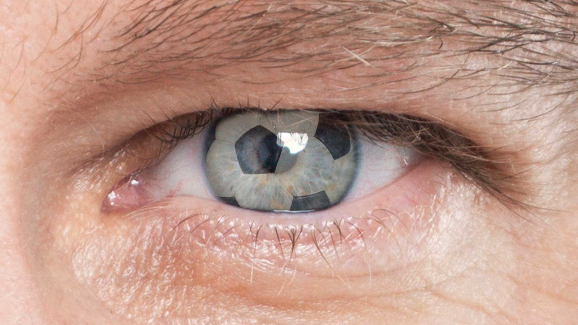 A person with a reflection of a football in their eye