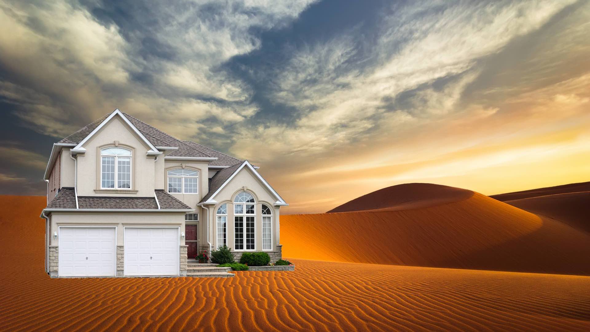 A house plonked in the middle of a very sandy desert