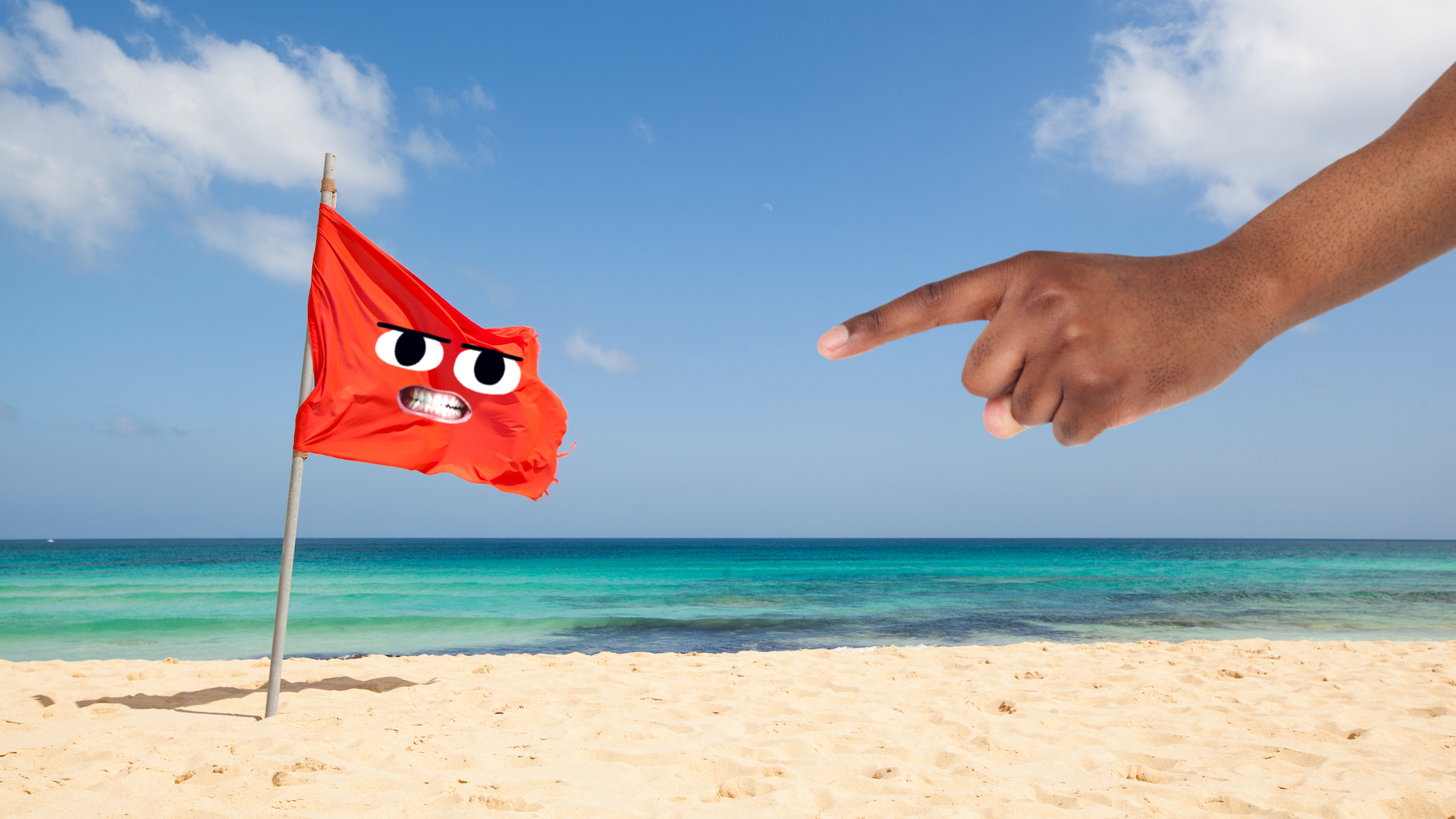 A red flag on a sandy beach