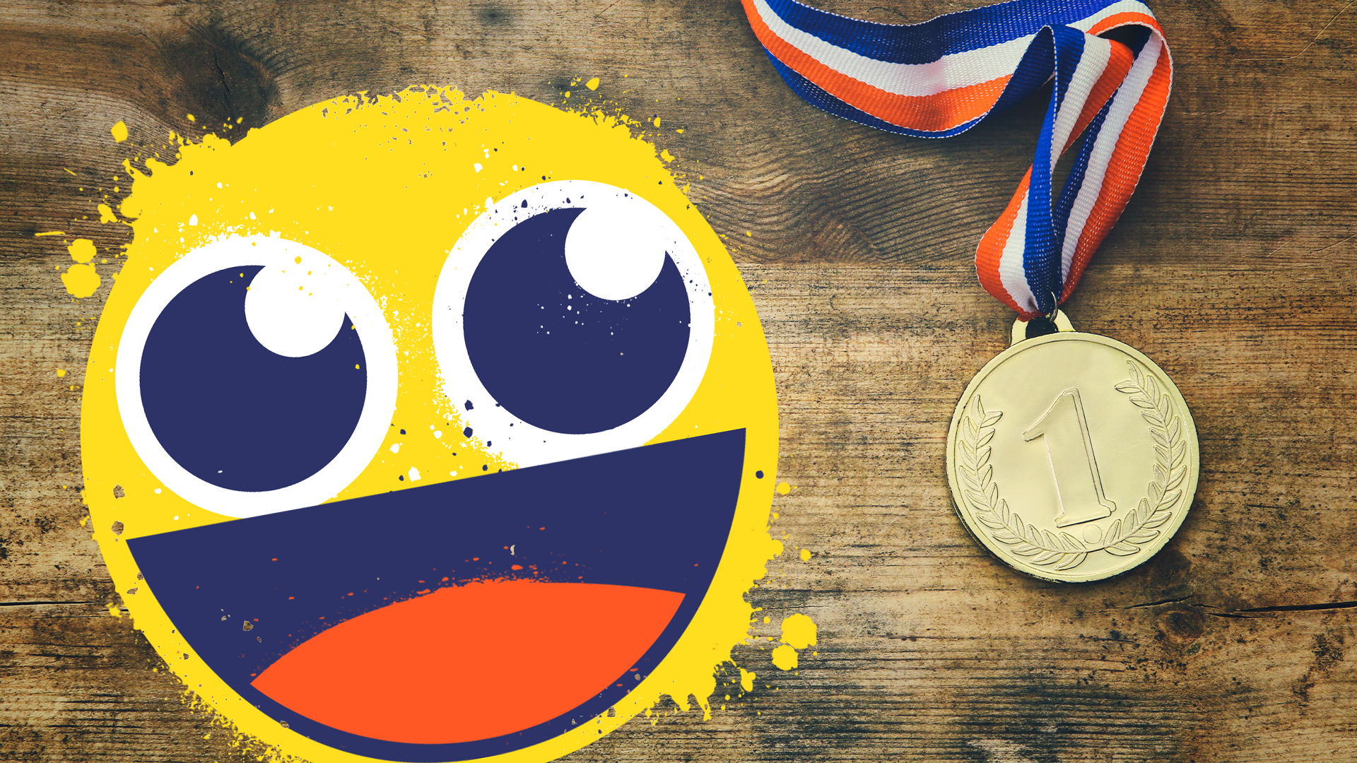 Smiling emoji with gold medal on wooden background