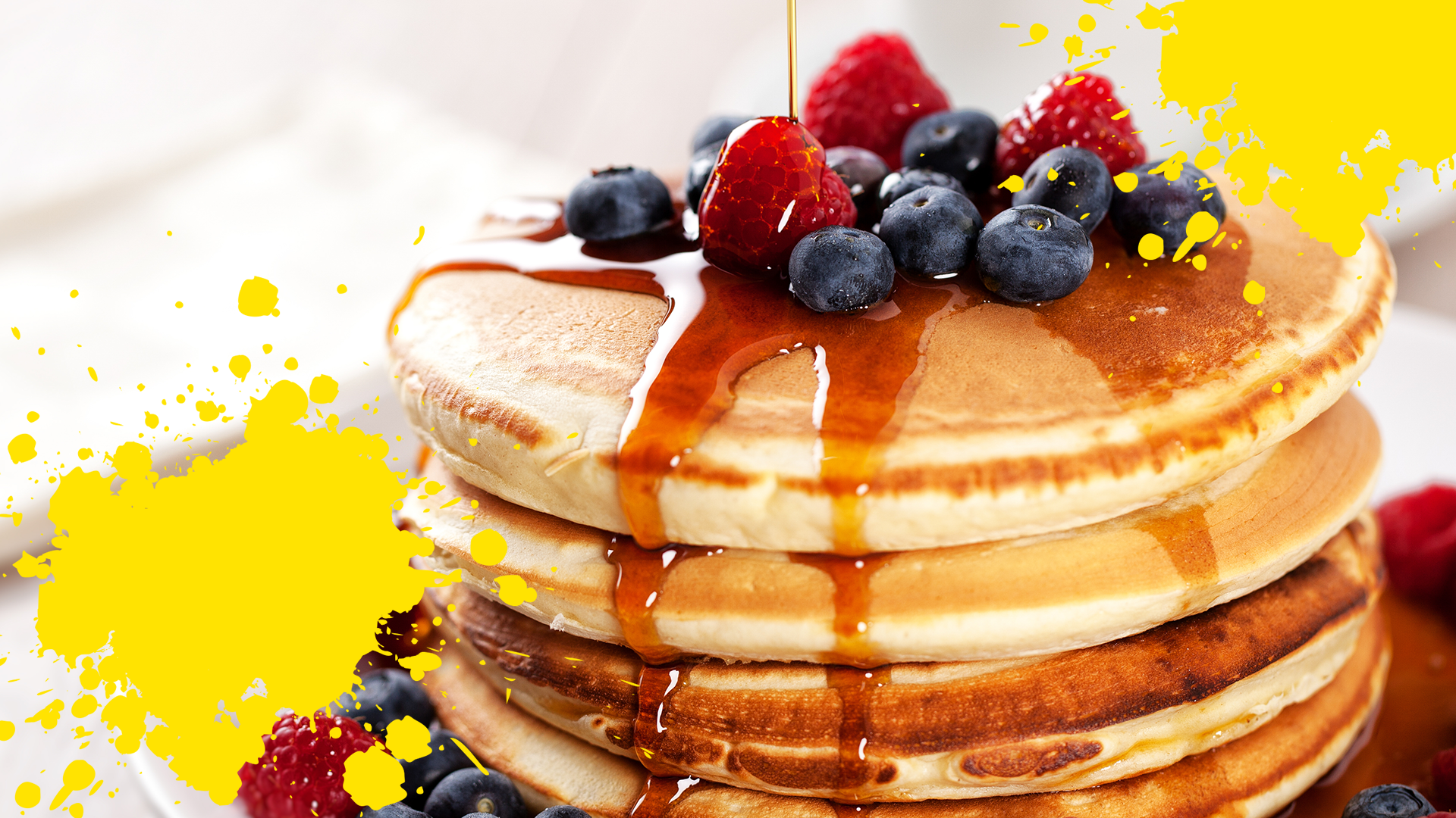 Pancakes and berries with yellow splats