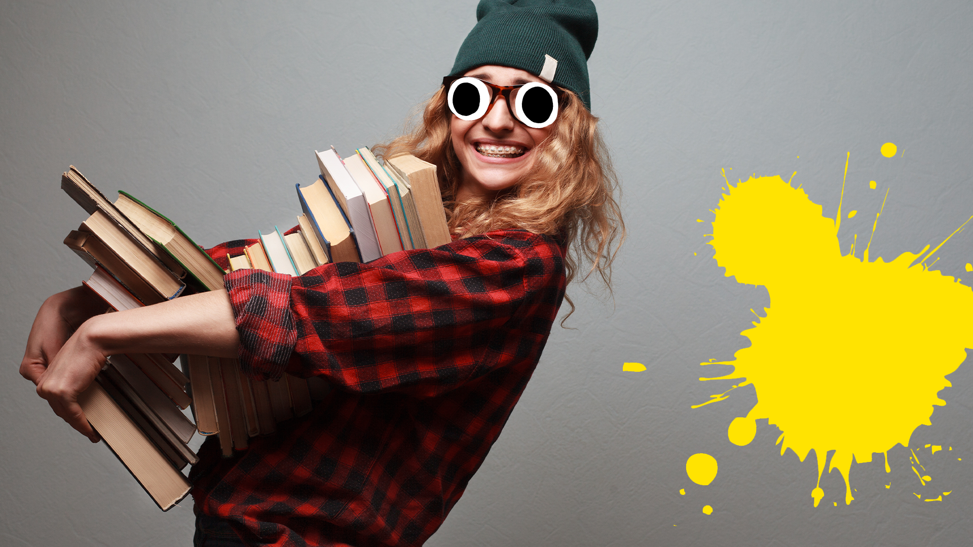 Girl with pile of books on grey background with splat
