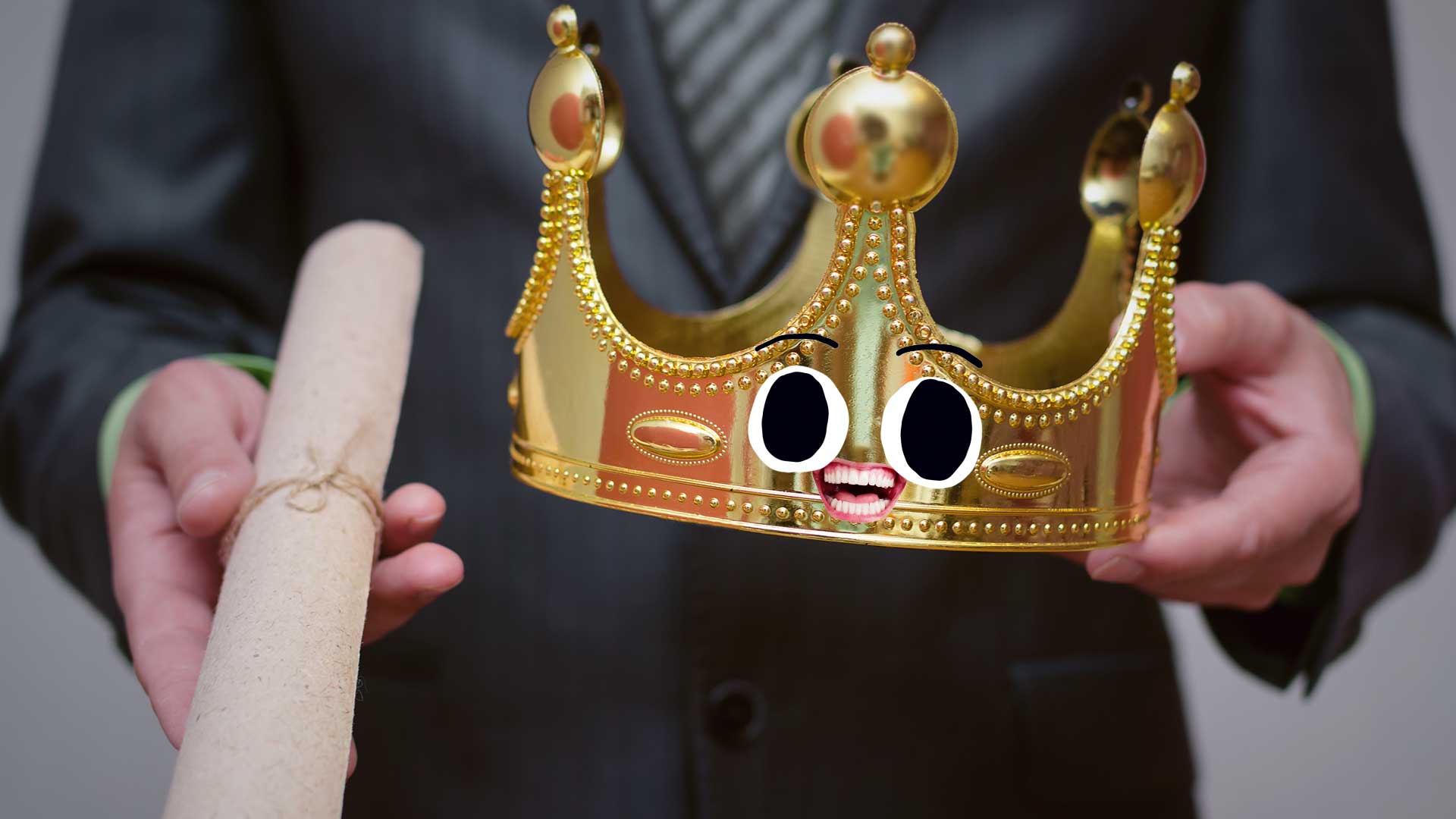 A person in a suit holding a scroll and a crown