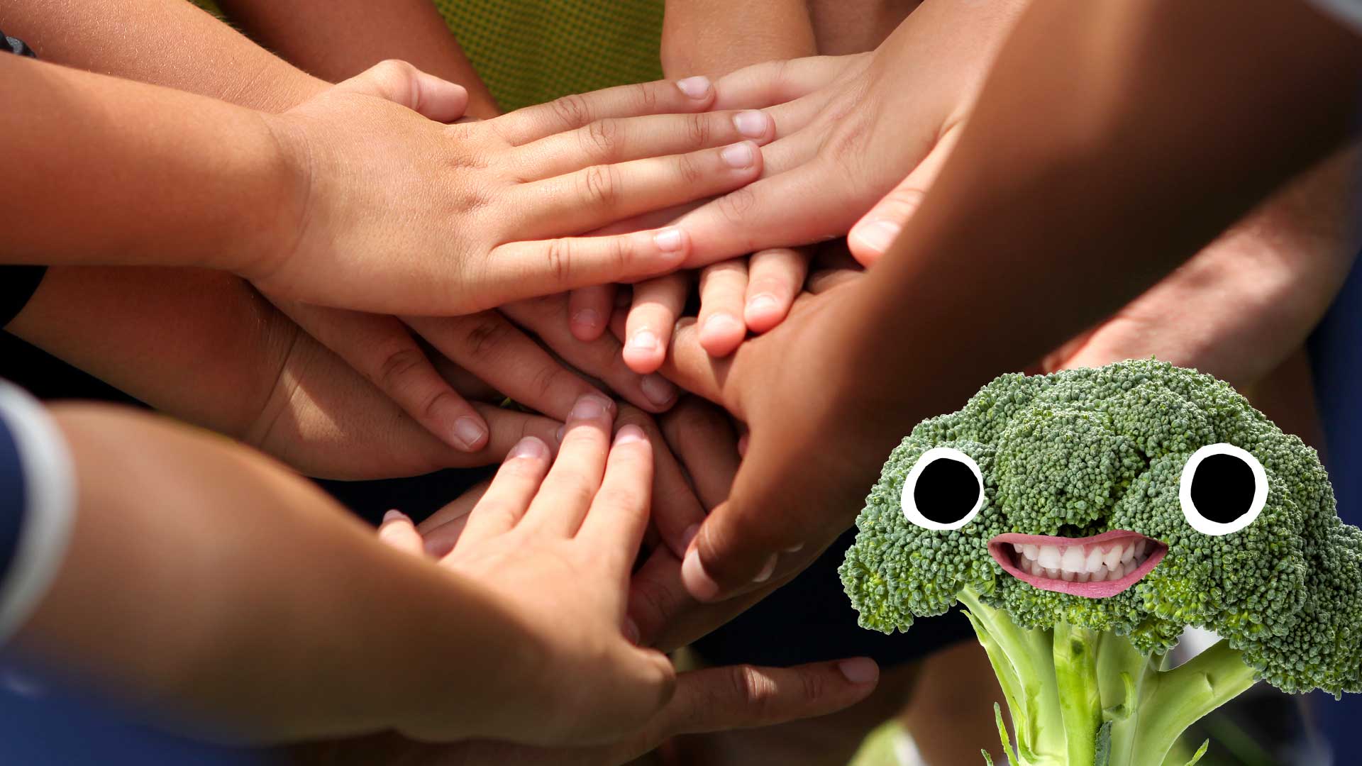 A team joining hands, while a piece of broccoli looks on