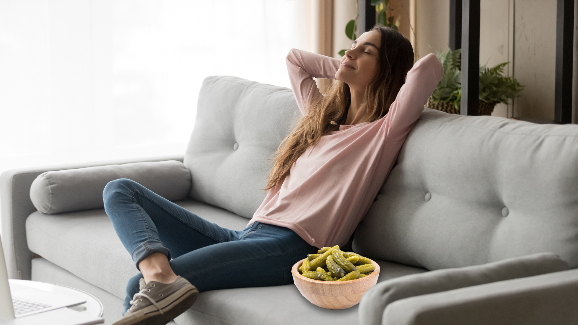Woman relaxing on the sofa with a bowl of pickles