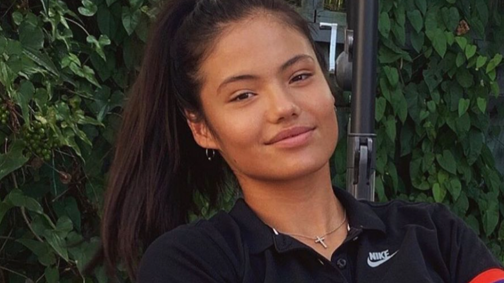 Emma Raducanu in a black polo shirt