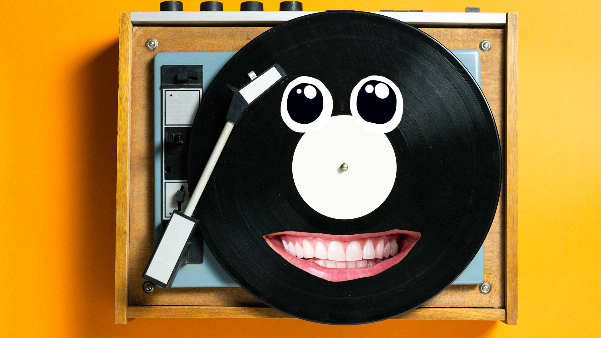 Record player and record with goofy face on orange background