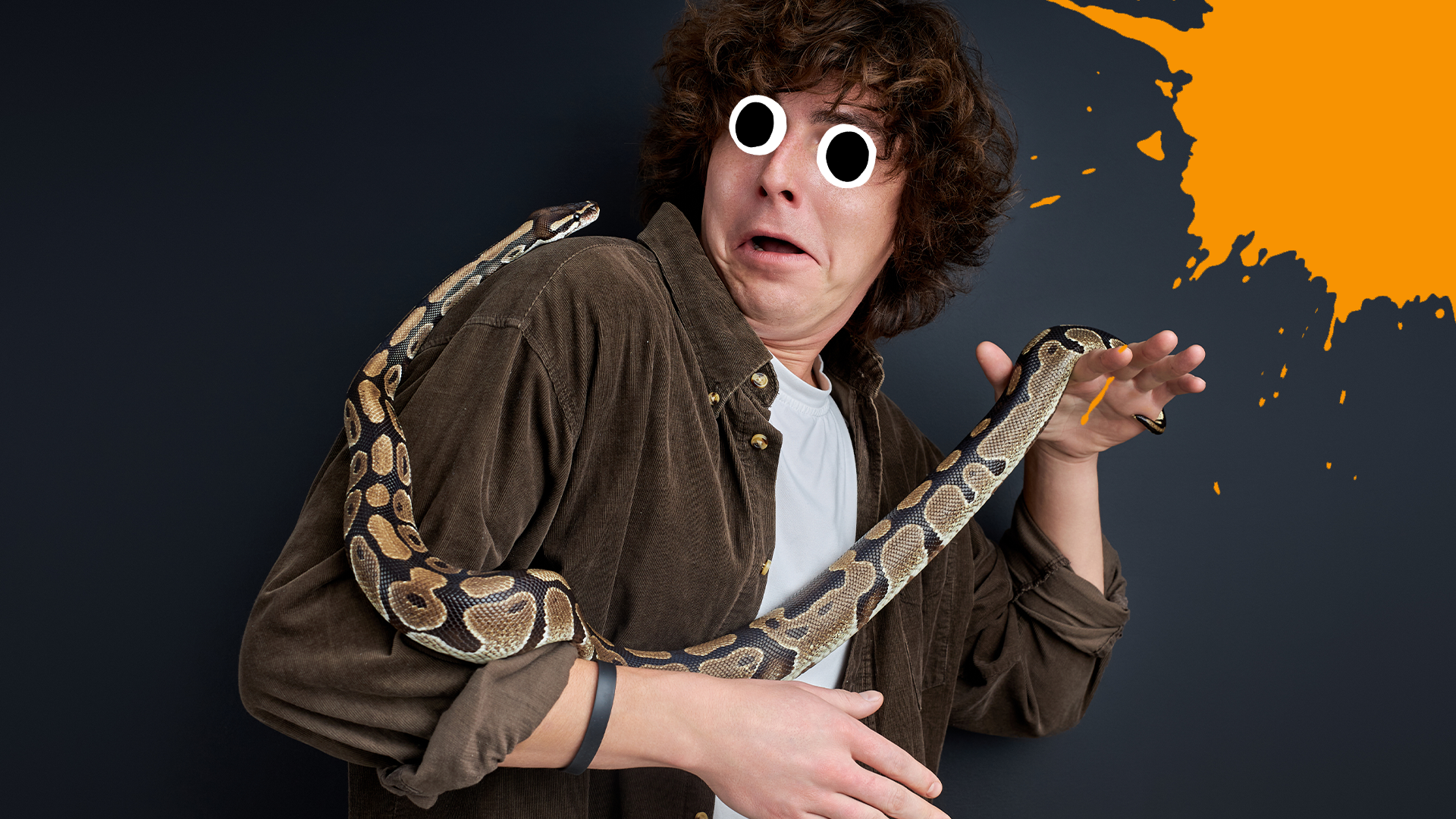 Man with snake looking scared on dark background with orange splat