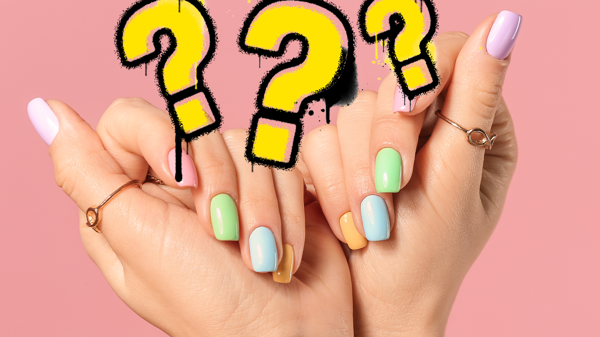 Woman's hands with colourful nails and question marks on pink background