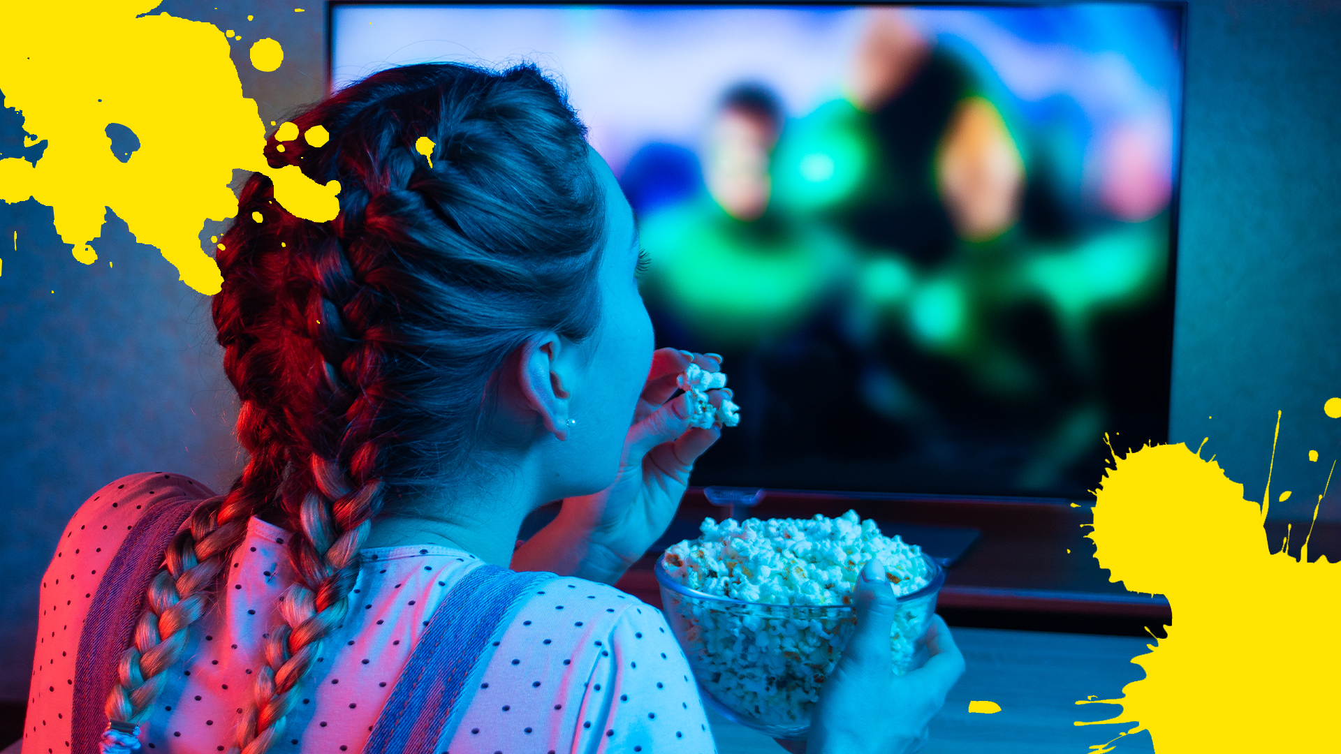 Girl eating popcorn and watching TV with yellow splats