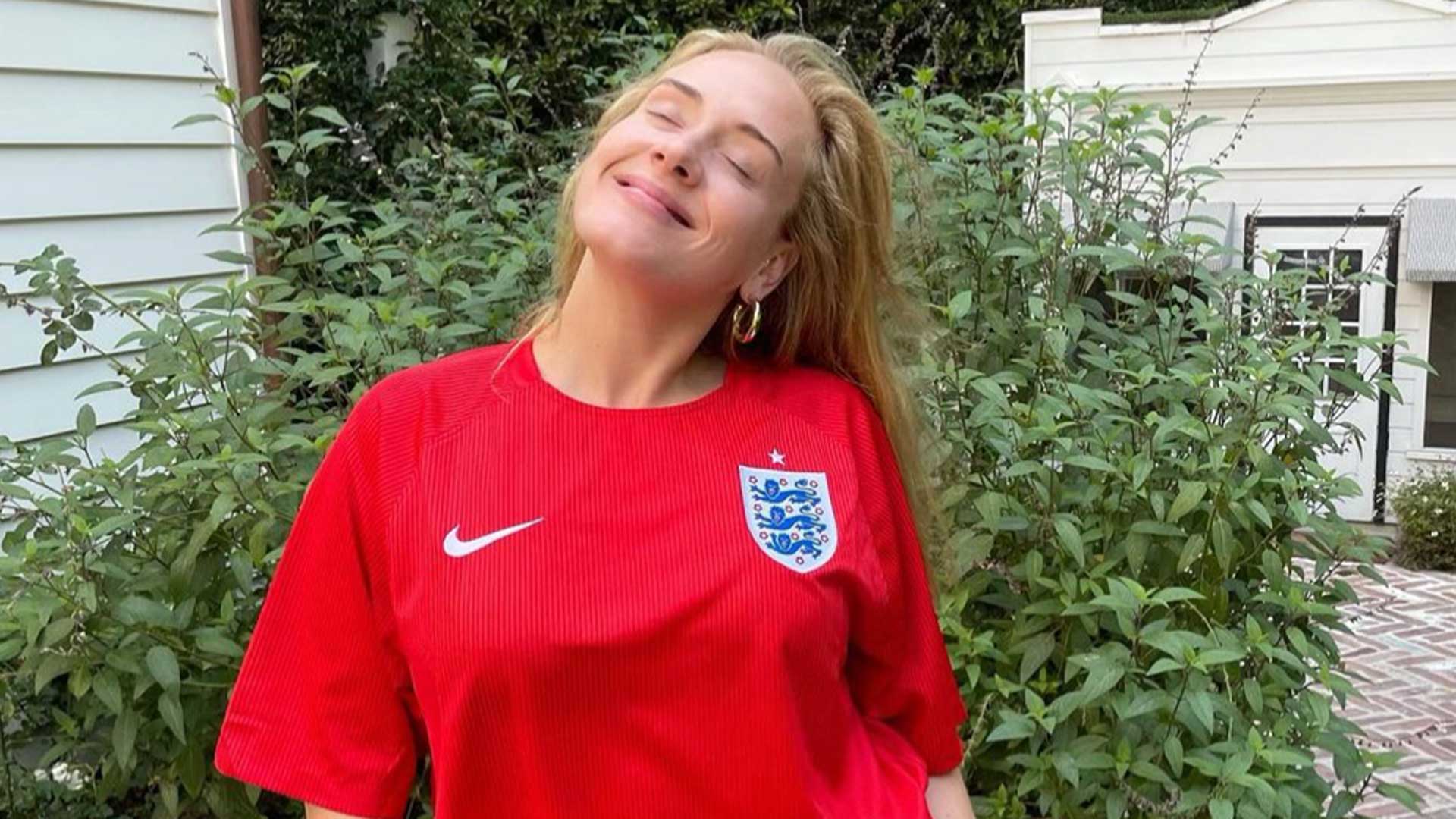 Adele in a red England shirt