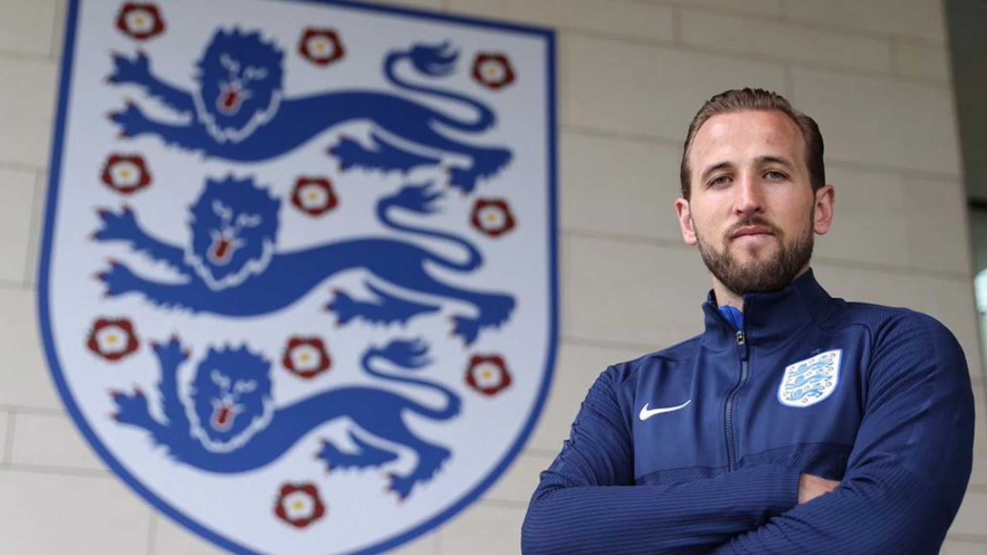 Harry Kane in front of a big England badge