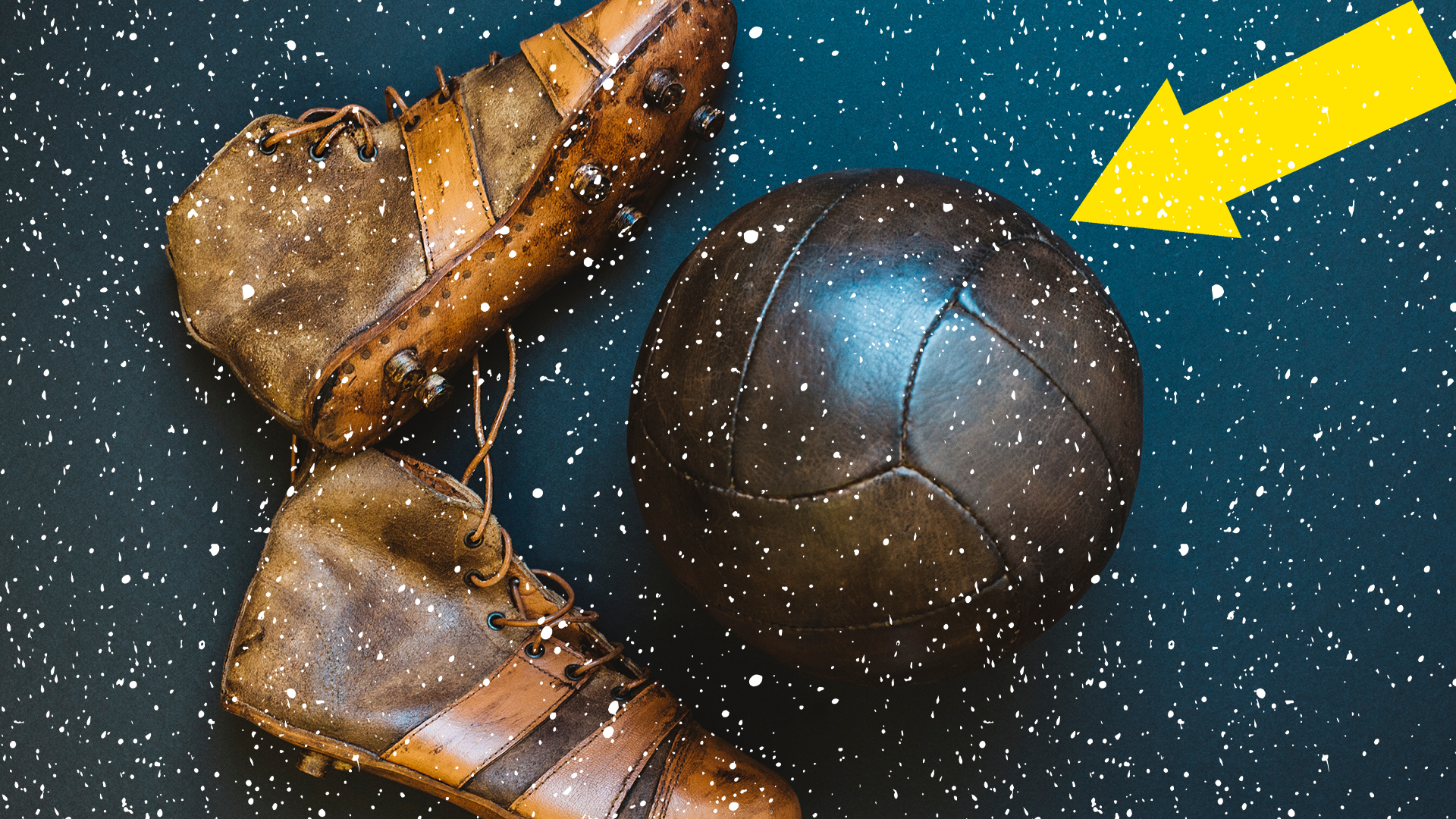 Old football boots, ball and arrow with snow