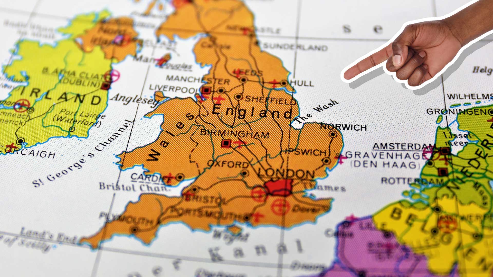 A hand pointing to the map of the UK