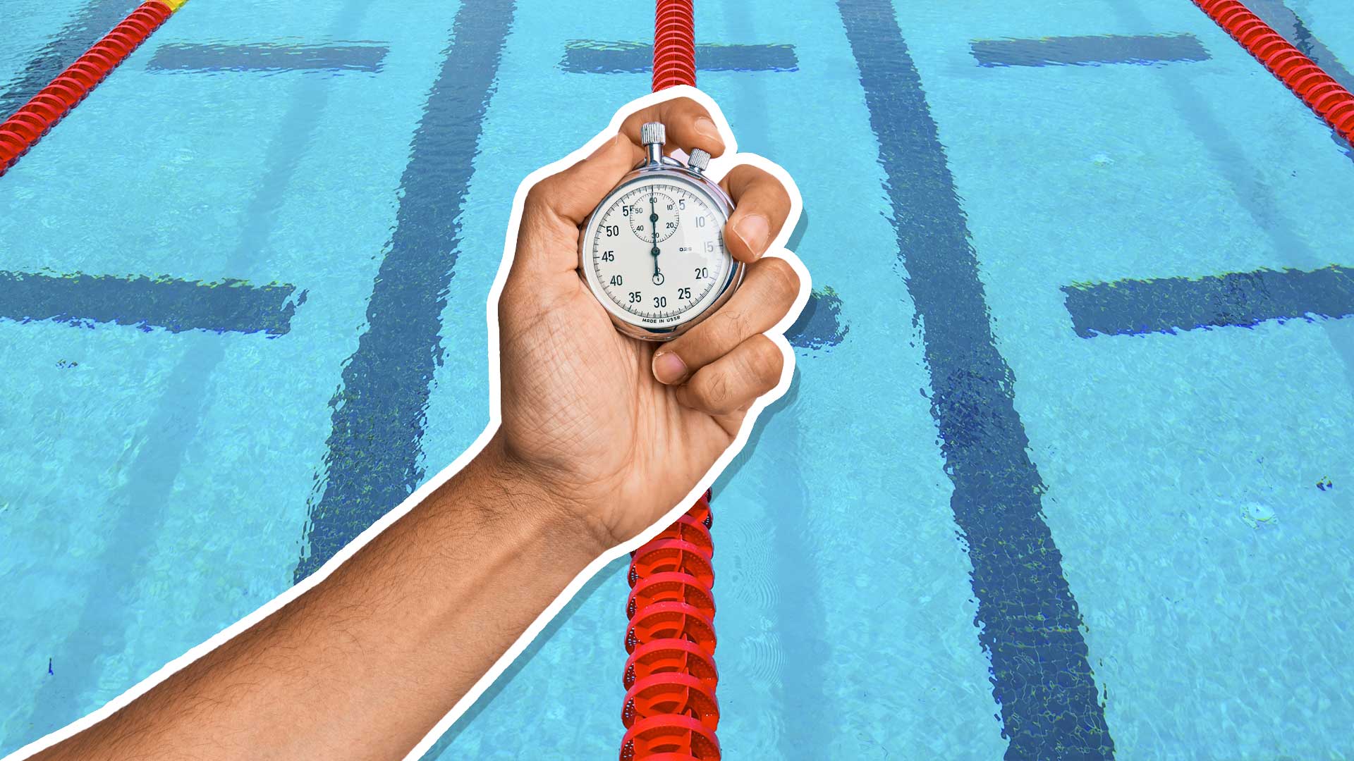 A man holding a stop watch at a large swimming pool