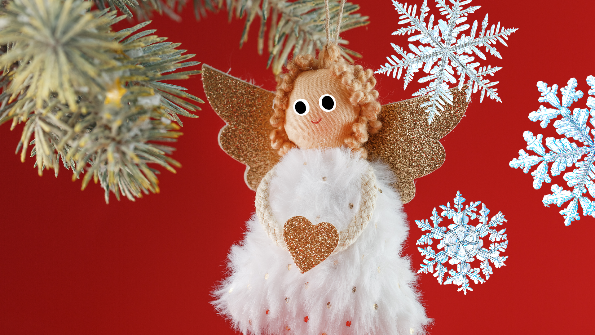 Angel decoration with snowflakes on red background