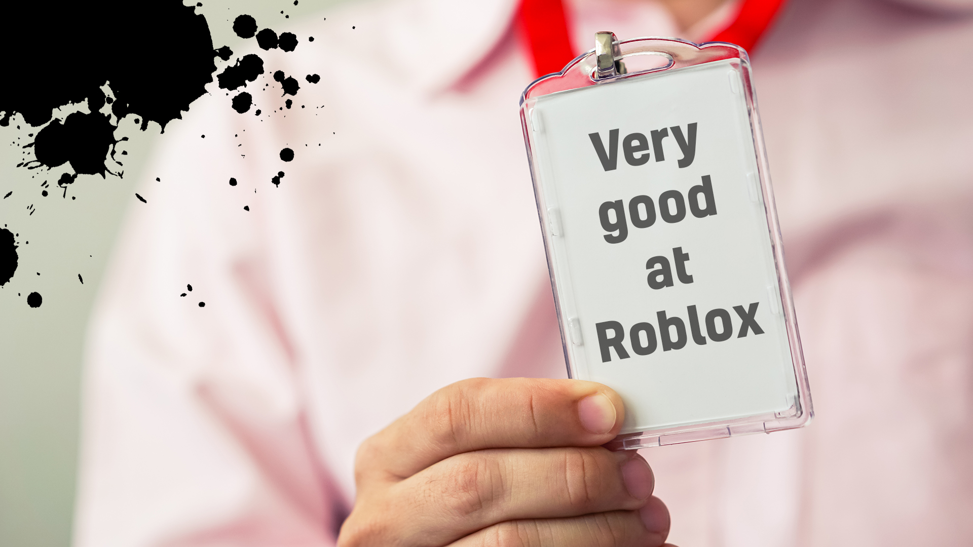A person holding a laminated pass which reads ‘very good at Roblox’