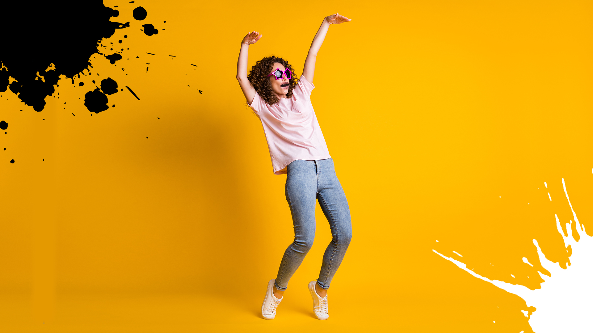 A person dancing in front of a yellow background