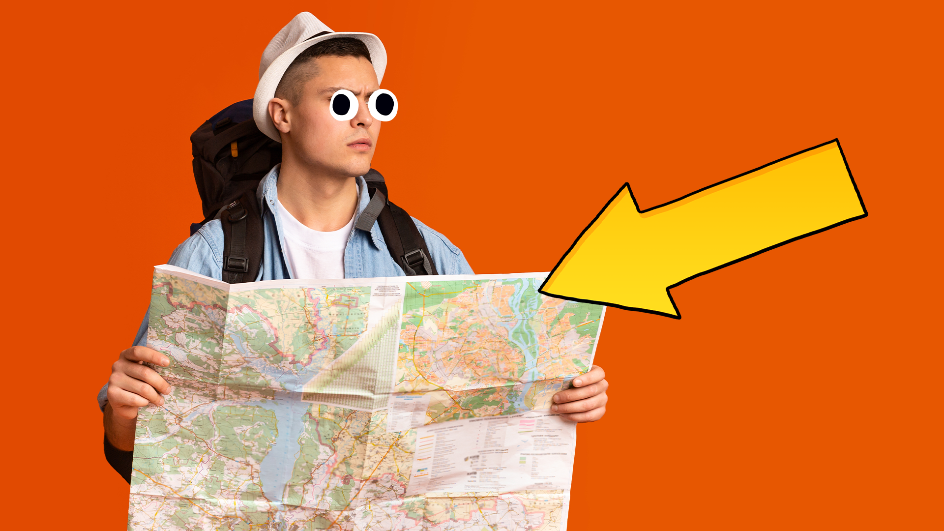 Man looking at map on orange background with arrow