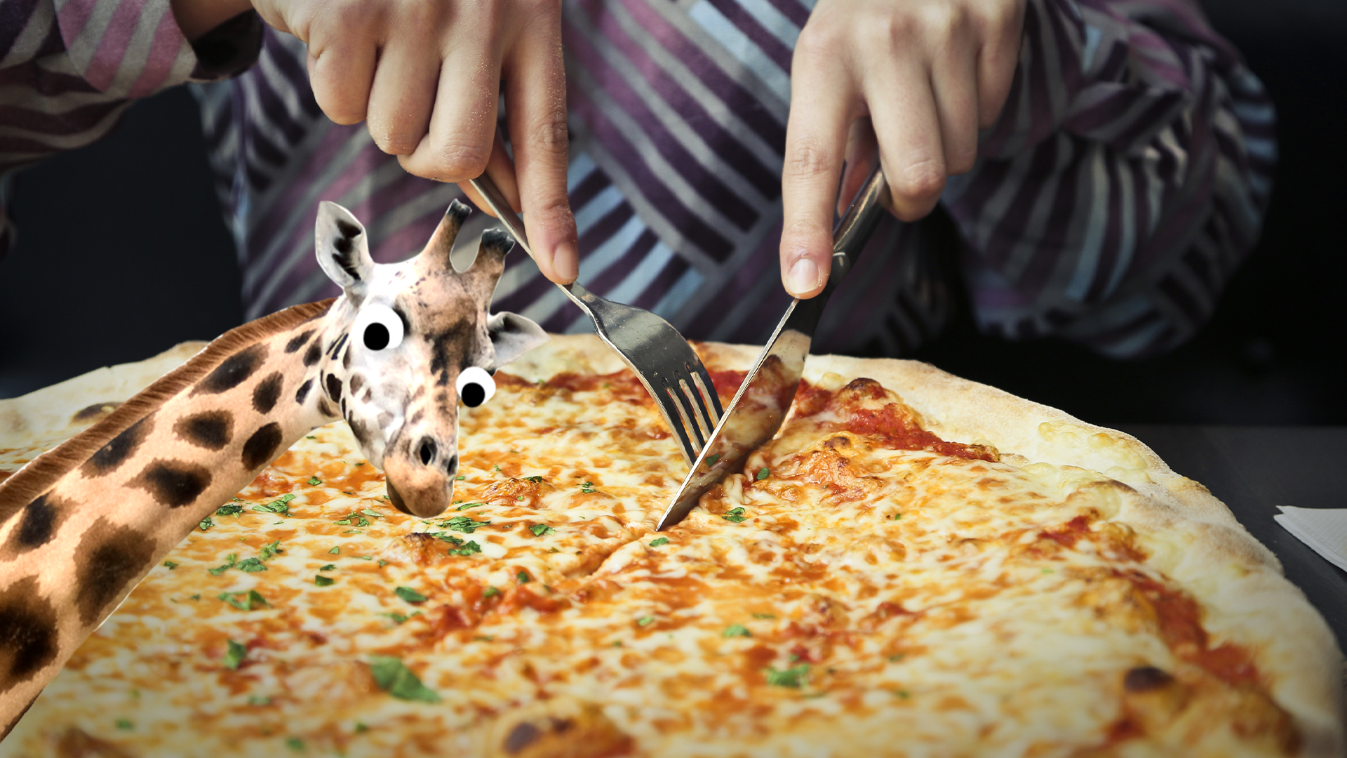 Someone eating pizza with Beano giraffe