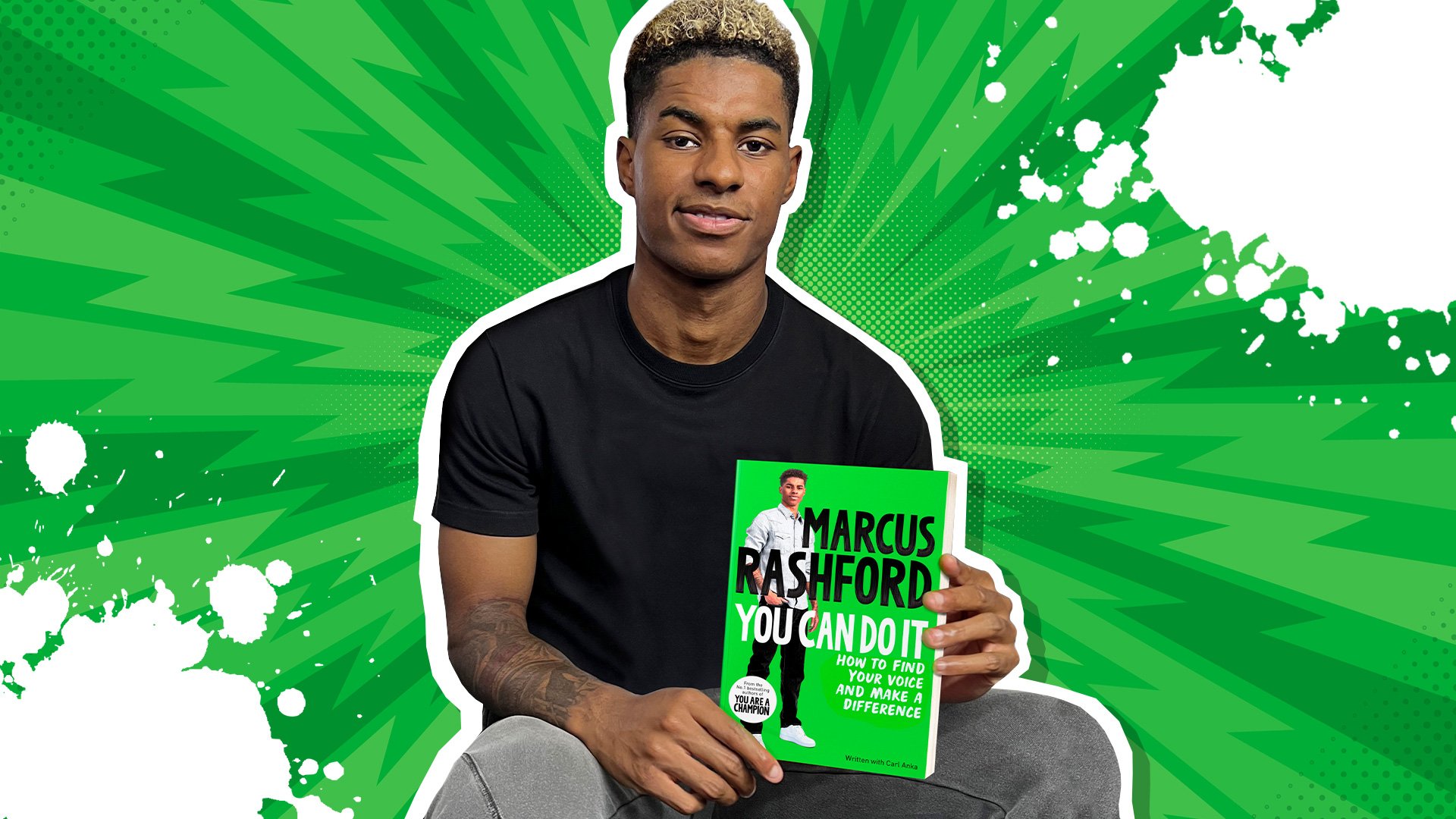 Marcus Rashford holding his new book, You Can Do It: How to Find Your Voice and Make a Difference, co-written with Carl Anka