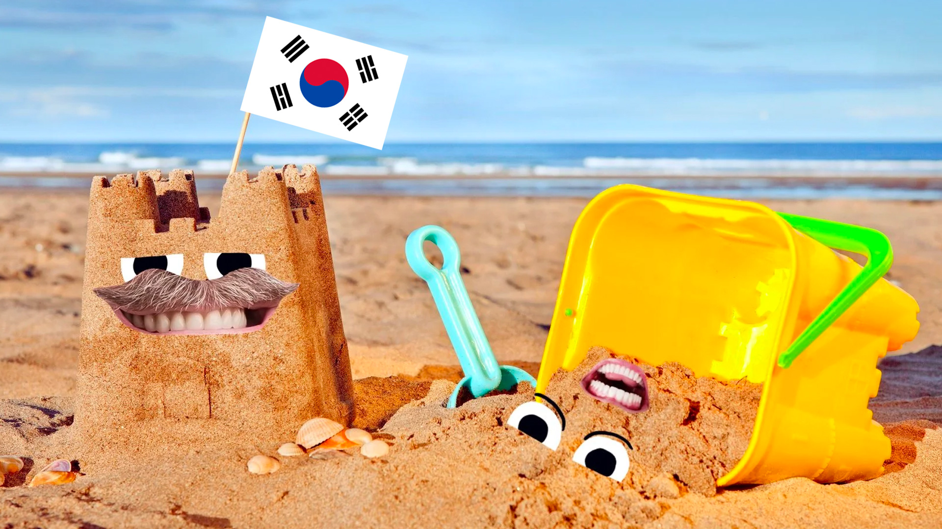 Sandcastle on beach with South Korea flag