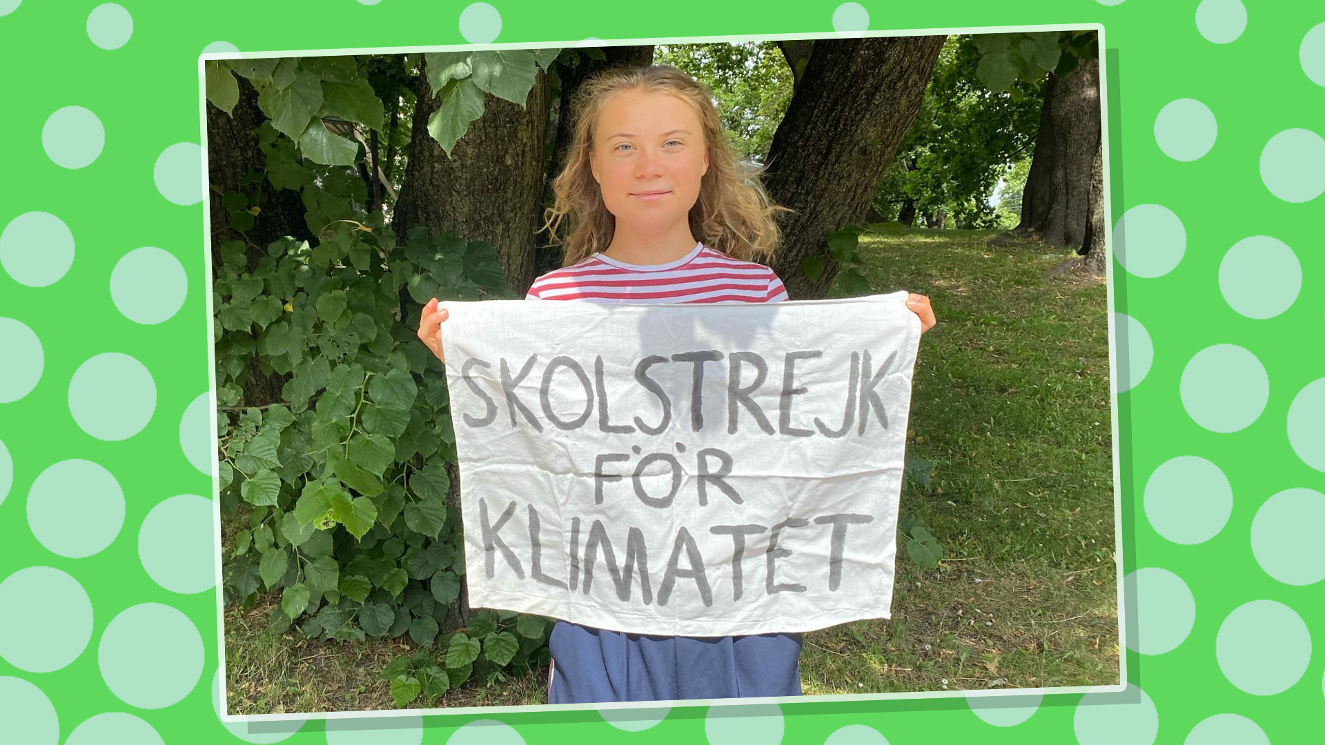 Greta Thunberg holding her iconic climate change banner