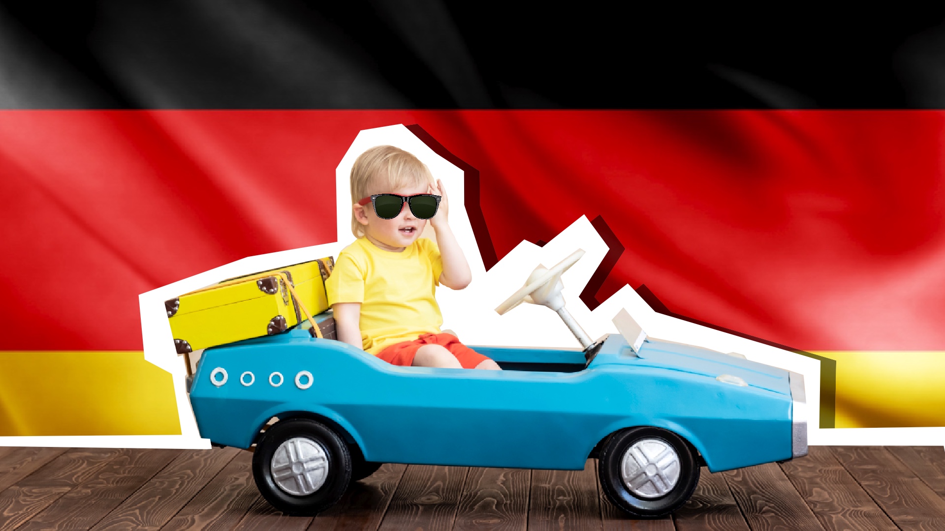A child sits in front of a car, with a German flag is displayed in the background