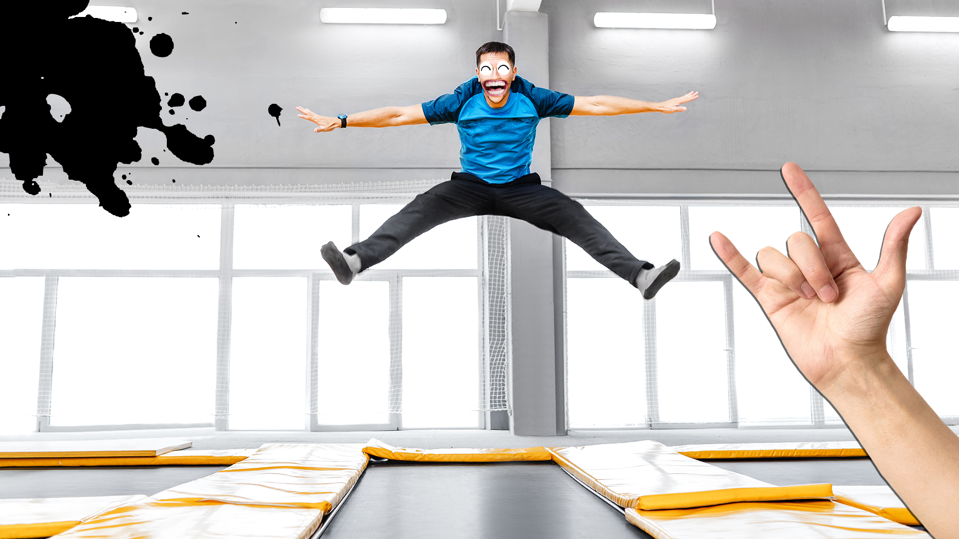 A man doing a big leap in a dance studio