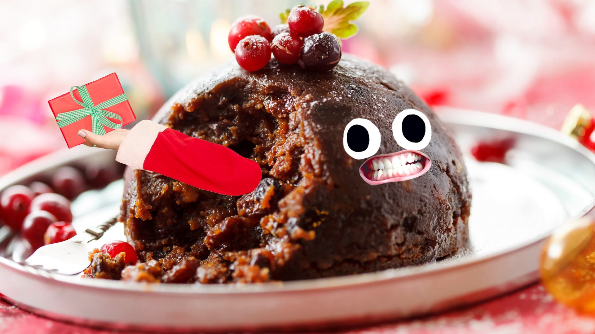 A Christmas pudding with Santa's arm holding a gift