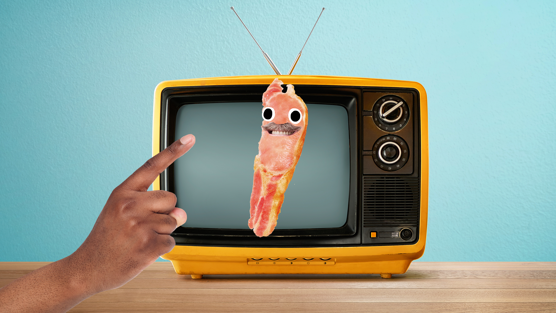 Someone pointing at an old tv with Bacon dad on it