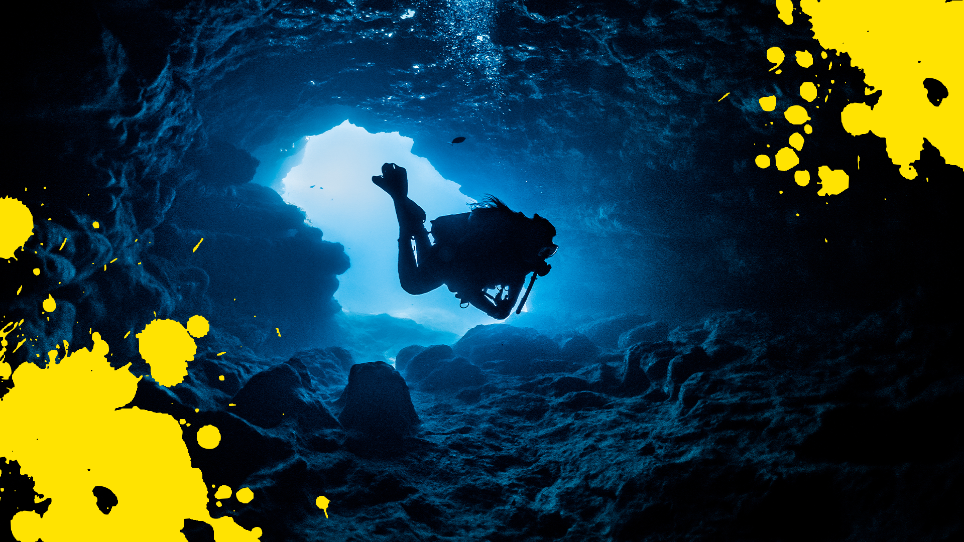 Diver in underwater cave and splats