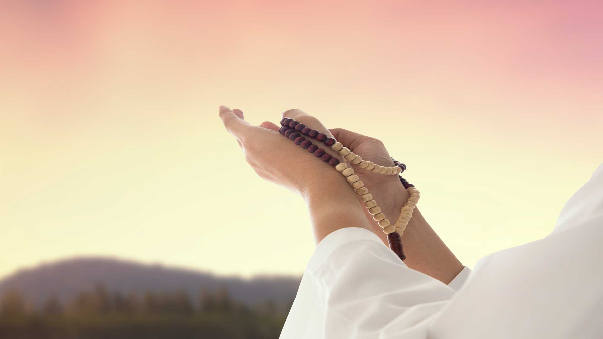 A Muslim woman holds prayer beads called Misbaha 