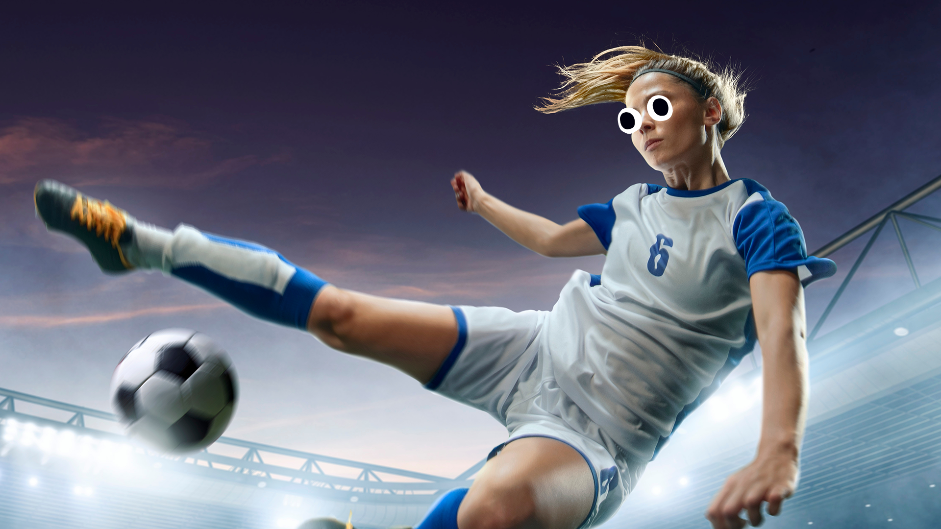Cool looking female footballer kicking the ball