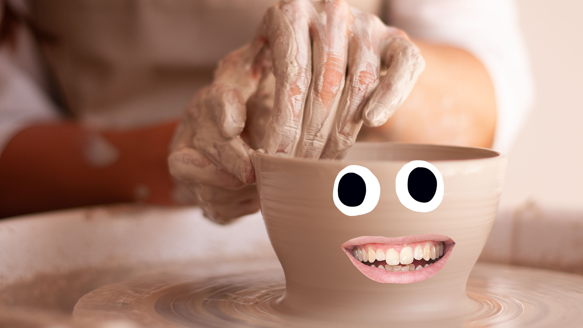 Someone making a pot with a goofy face