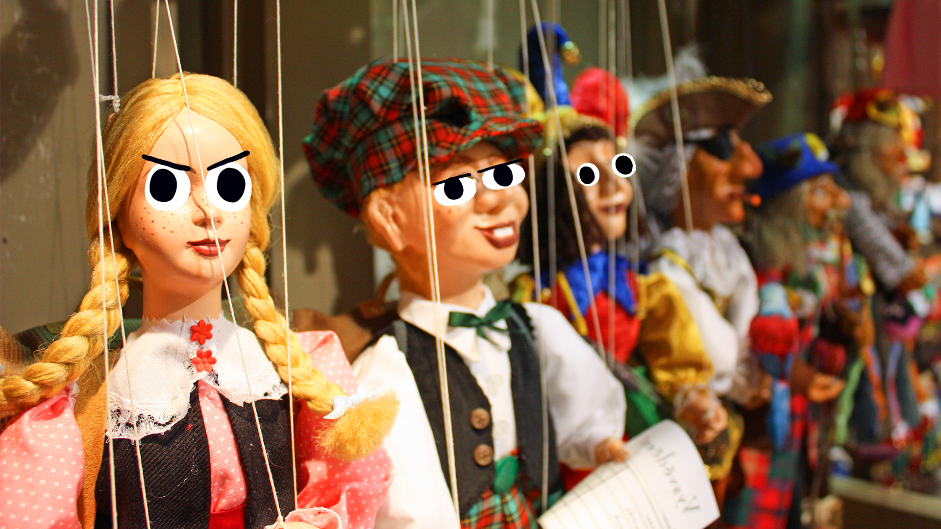 A row of sinister traditional puppets