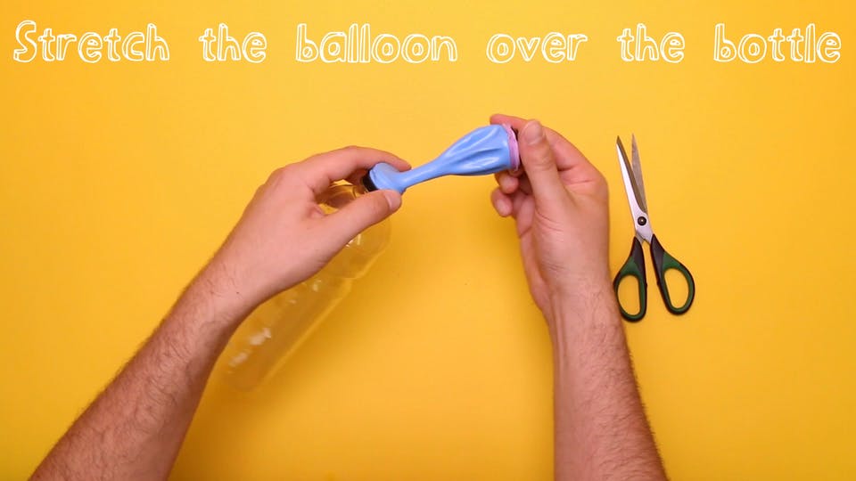 Stretch the balloon over the bottle