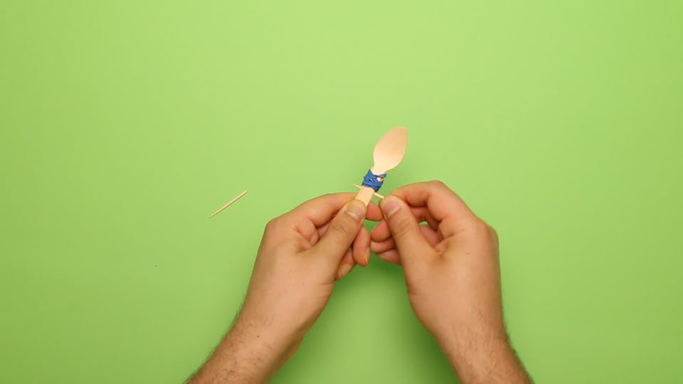 Poke the 2 halves of the cocktail stick between the spoons