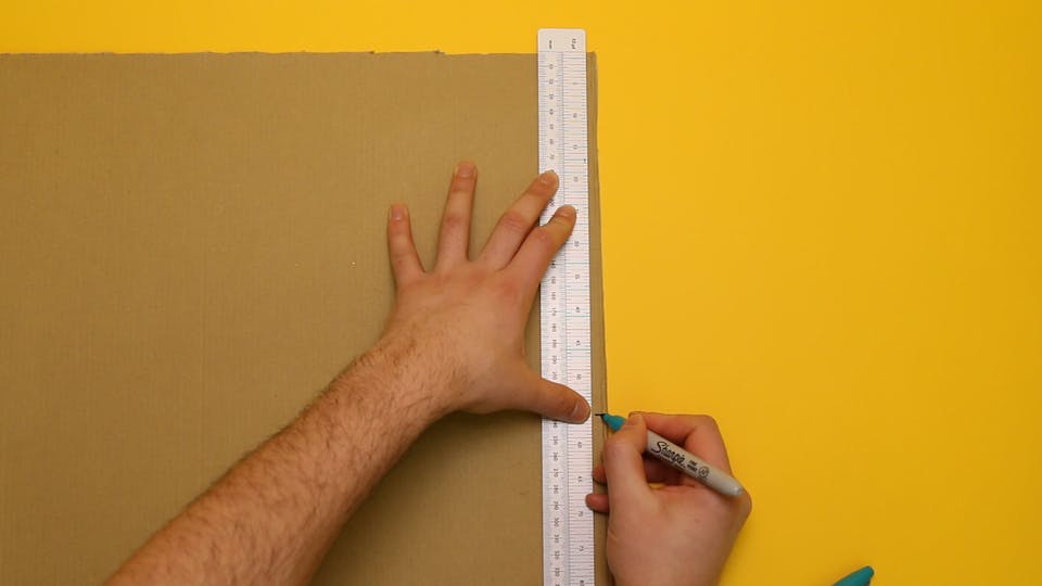 Measure the length of the tube and mark the cardboard
