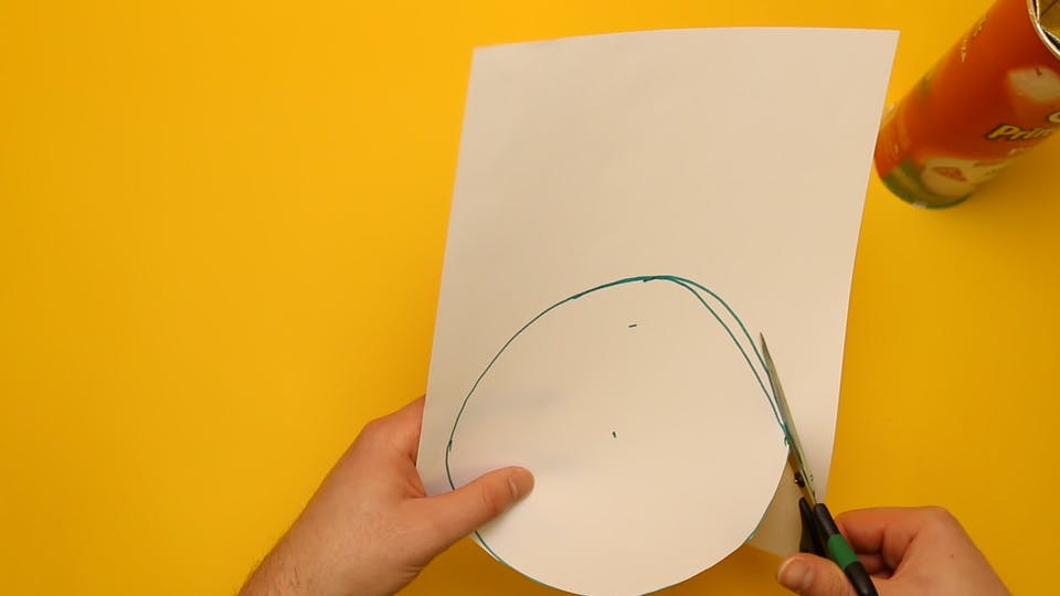 Draw a circle on a sheet of paper and then cut it out