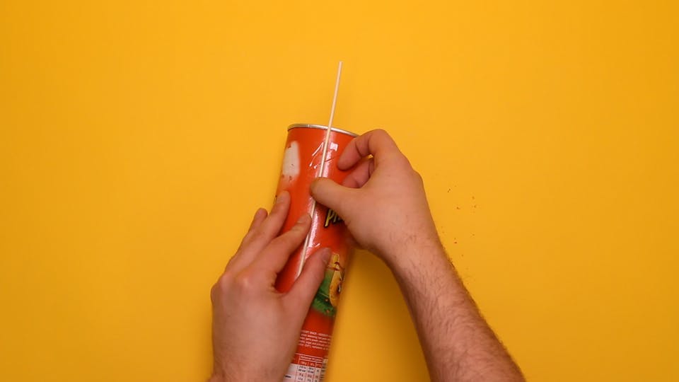 Tape a wooden skewer to the side of the tube