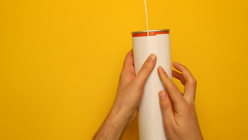 Wrap a sheet of paper around the tube and tape it to hold it in place