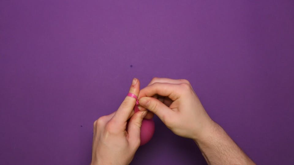 Tie the balloon in a knot. The balloon might be wet and slippery, so make sure you don't drop it!
