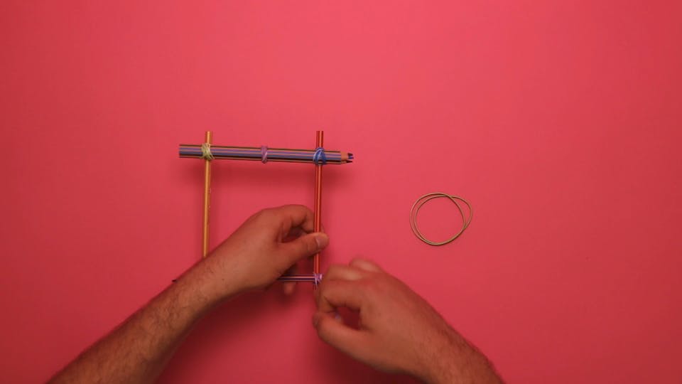 Use the other three pencils to make a frame, fixed with more rubber bands