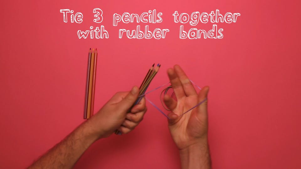 Take three pencils and wrap them together using rubber bands