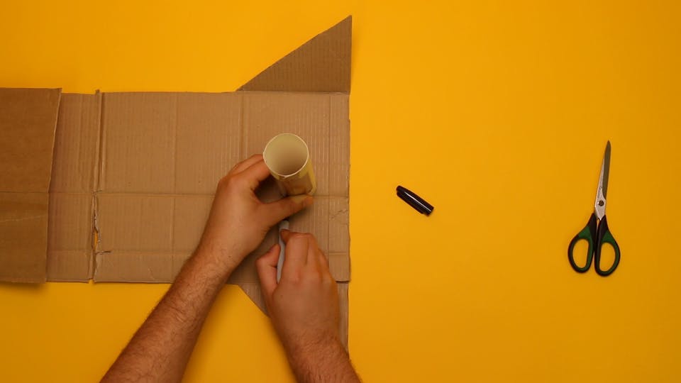 Trace the end of the tube, marking out a circle on the end panel of your cardboard