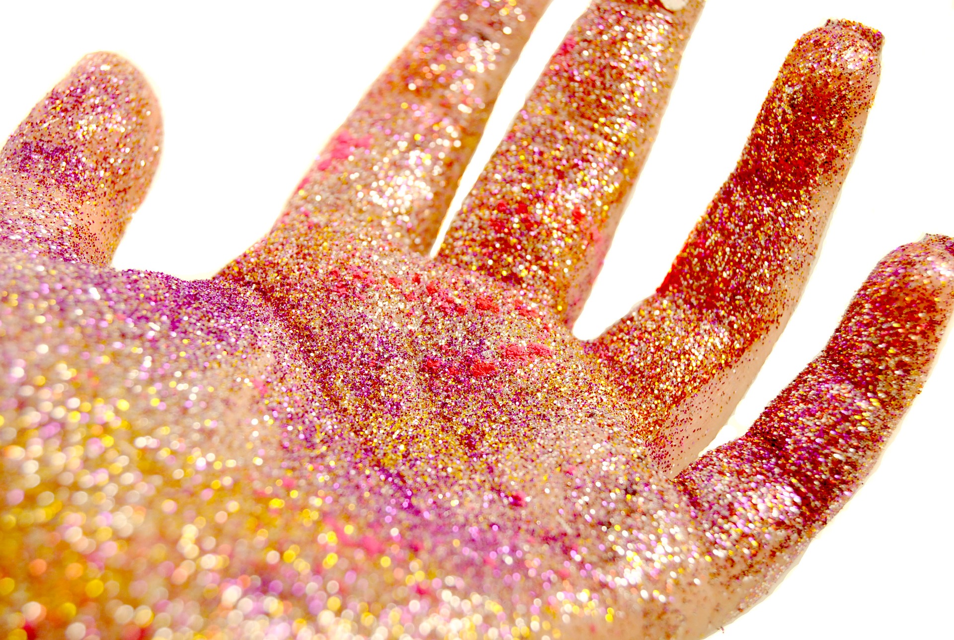 A hand covered in glitter