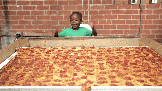 A kid with a giant pizza