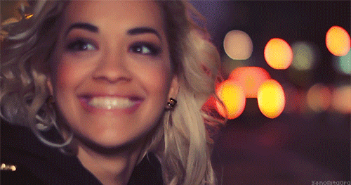 Rita Ora grins at the camera